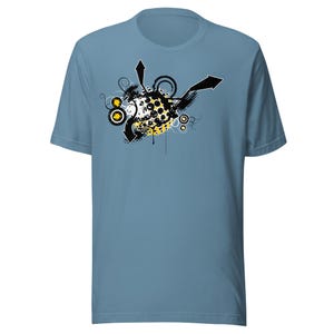 May include: A light blue t-shirt with a black and white graphic design featuring a yellow circle with black dots and arrows pointing in different directions.