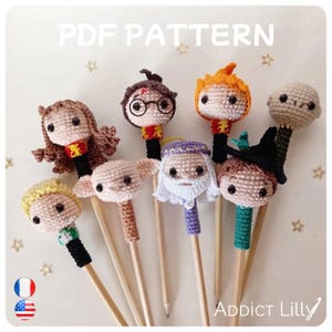May include: A collection of eight crochet pencil toppers featuring various character designs with yarn hair, hats, and outfits. The text PDF PATTERN is visible at the top, and the text ADDICT LILLY is visible at the bottom right corner.