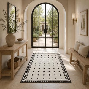 May include: A rectangular floor runner rug featuring a cream-colored base with a repeating pattern of small black diamonds and a thick black geometric border. The rug is positioned in a hallway with a wooden console table and a wooden bench.