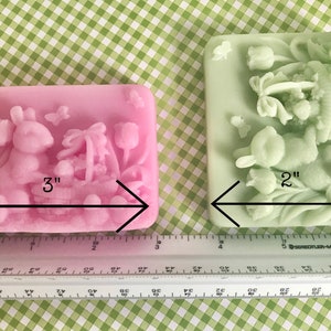 May include: Two Easter-themed silicone molds, one pink and one green, with a bunny and basket design. The pink mold is 3 inches wide and the green mold is 2 inches wide.