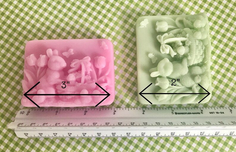 May include: Two Easter-themed silicone molds, one pink and one green, with a bunny and basket design. The pink mold is 3 inches wide and the green mold is 2 inches wide.