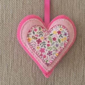 A handmade bright pink floral felt heart door hanging decoration. Gift for her.