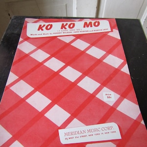 May include: A red and white checkered sheet music cover with the title "Ko Ko Mo (I Love You So)" and the words "Words and Music by Forest Wilson, Jake Porter and Eunice Levy". The price is listed as 50c. The publisher is Meridian Music Corp. located at 35 West 51st Street, New York 19, New York.