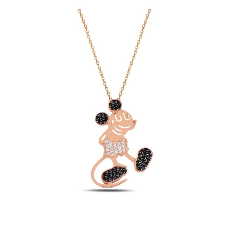 May include: A rose gold necklace with a Mickey Mouse pendant. The pendant is made of silver and is covered in black and white cubic zirconia stones.