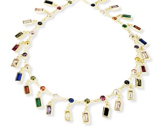 May include: A gold chain necklace with colorful rectangular and round gemstones. The necklace has a delicate design with multiple strands of chain and dangling gemstones.