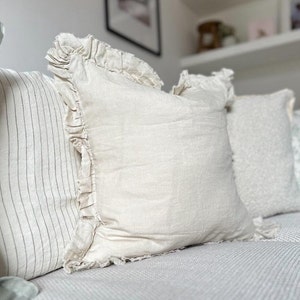 cream cushion with a ruffled edge