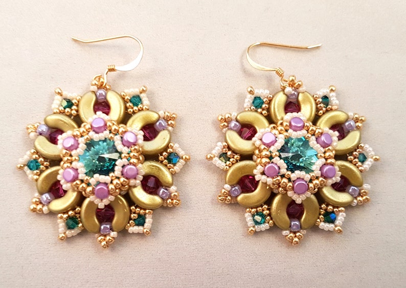 以下が含まれることがあります： ターコイズ、ピンク、白のビーズでデザインされた、ゴールドのイヤリングのペア。イヤリングは花の形をしていて、ゴールドのフックが付いています。