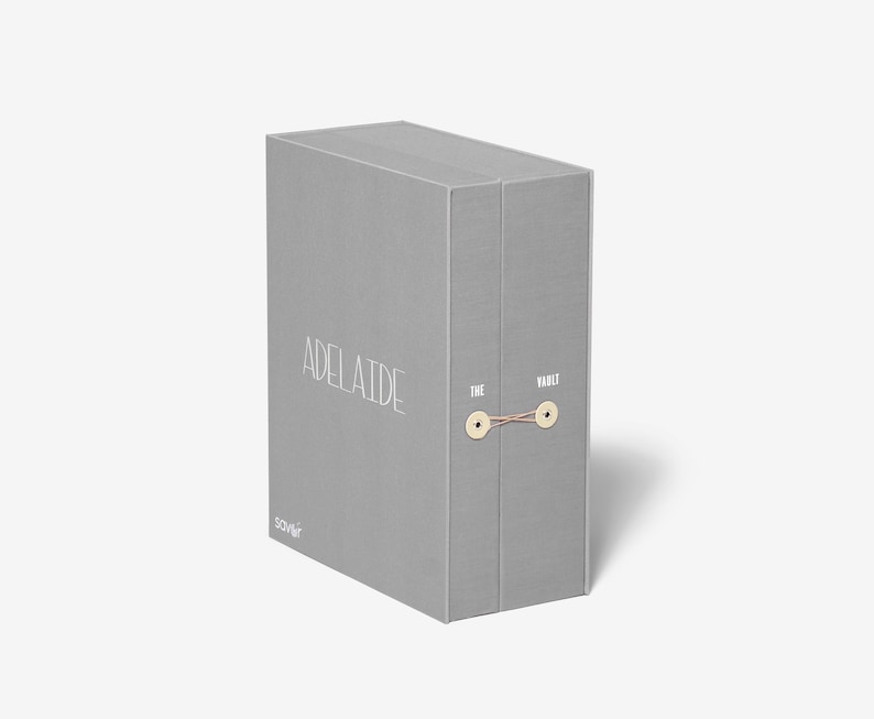 May include: A gray box with the text "Adelaide" and "The Vault" printed on it. The box is tied with a string.