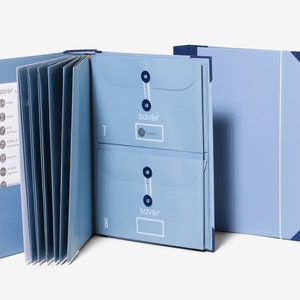 May include: A light blue folder with multiple pockets and a Saviler logo. The folder is open to reveal a series of envelopes with the Saviler logo and numbered tabs.
