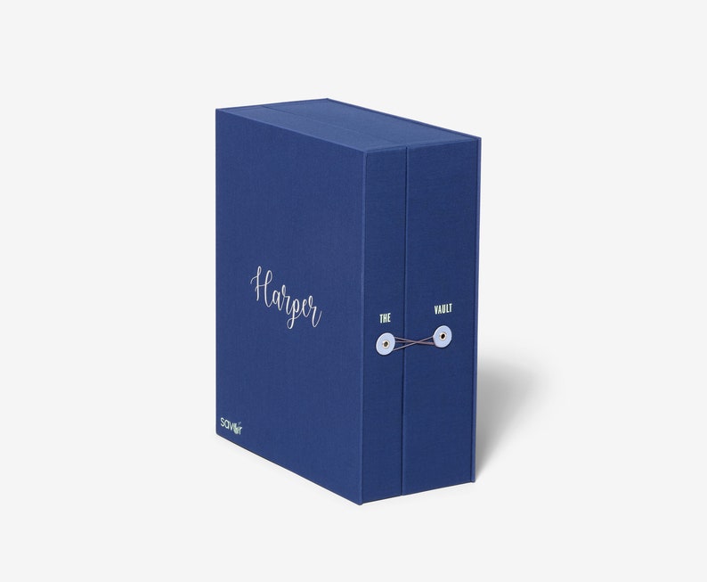 May include: A blue box with the text "Harper" and "The Vault" printed on it. The box has a string closure and is made of a textured material.
