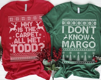 May include: Two Christmas themed t-shirts with a red and green color scheme. The red shirt has a white design that says "Why is the carpet all wet Todd?" The green shirt has a white design that says "I don't know Margo".
