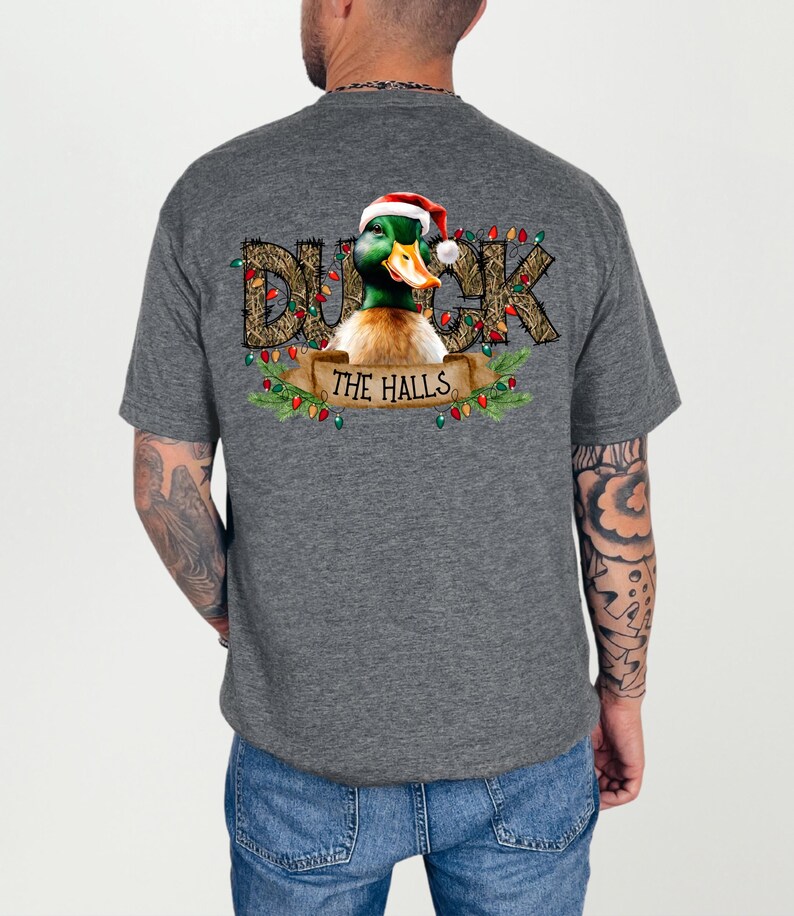 May include: A gray t-shirt with a Christmas-themed design featuring a duck wearing a Santa hat and the text "Duck the Halls".