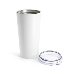 May include: A white tumbler with a silver rim and a clear lid. The tumbler is cylindrical and appears to be made of metal. The lid is clear with a black and silver rim. The tumbler is designed to keep beverages hot or cold.