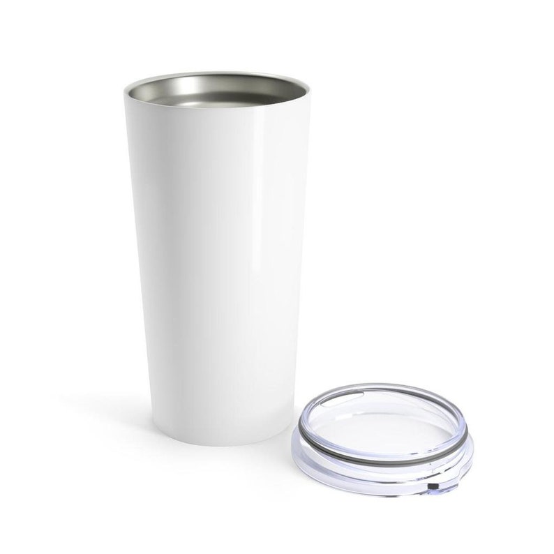 May include: A white tumbler with a silver rim and a clear lid. The tumbler is cylindrical and appears to be made of metal. The lid is clear with a black and silver rim. The tumbler is designed to keep beverages hot or cold.