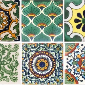 May include: Twelve square ceramic tiles with intricate designs in shades of green, yellow, blue, and red. The tiles feature floral patterns, geometric shapes, and stylized motifs.