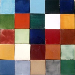 May include: A collection of 25 square ceramic tiles in various colors, including blue, green, red, orange, yellow, and brown. The tiles are arranged in a grid pattern.