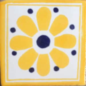 May include: A yellow and blue ceramic tile with a stylized flower design. The flower has eight petals and a blue center.