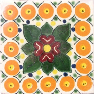 May include: A square ceramic tile with a floral design. The tile has a white background with a green, red, and yellow flower in the center. The flower is surrounded by a border of orange circles.
