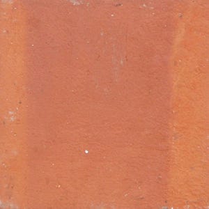 May include: A close-up of a red brick with a rough texture.