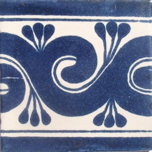 May include: A white tile with a blue and white pattern. The pattern features a repeating design of stylized swirls and leaves.