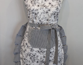 Adult apron. Woman's apron. Black petite floral on white. Black and white stripes on pocket, ties and frills.