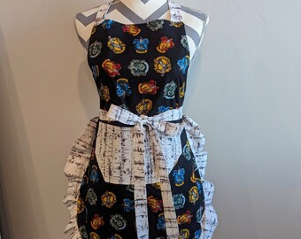 Adult apron. Womans apron. Colorful symbols on black. White with gray on pocket, ties and frills.