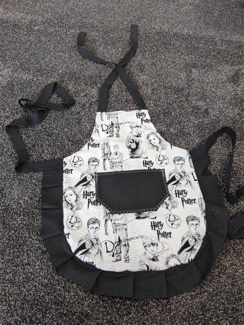 Harry Potter black images on white ties and frills. Black with mini black polka dots on pocket Girl/'s apron Youth apron
