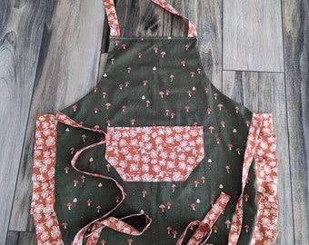 Adult apron. Woman's apron. Gorgeous green apron with mushrooms on main. Rusty orange florals on pocket ties and frills.