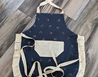 Adult apron. Woman's apron. Beautiful blue with dainty rose gold floral. Tan print on pocket, ties and frills.