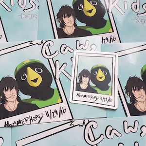 May include: A set of stickers featuring a cartoon character with a black and green bird head. The stickers have a blue background with white text that says "Caw, Kids!" and the date "11/29/16".