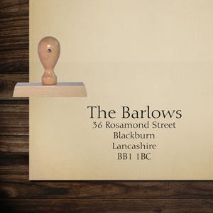 May include: A wooden self-inking stamp with the text "The Barlows, 36 Rosamond Street, Blackburn, Lancashire, BB1 1BC".