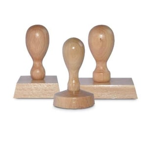 May include: Three wooden stamps with different sized bases and round wooden handles. The stamps are made of light brown wood.