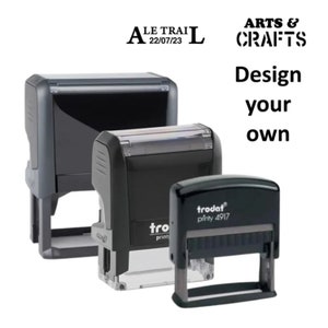 May include: Three black self-inking stamps with clear plastic tops. The stamps are labelled "trodat printy 4917", "trodat printy", and "A LE TRAIL 22/07/23". The text "ARTS & CRAFTS Design your own" is in the top right corner of the image.