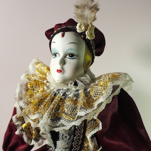 Antique collectible porcelain doll Harlequin.