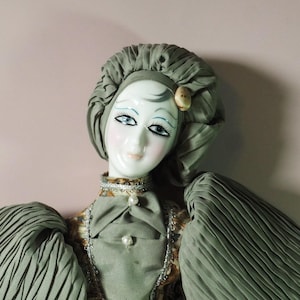 Vintage Venetian porcelain doll Harlequin. Handmade. On a stand.