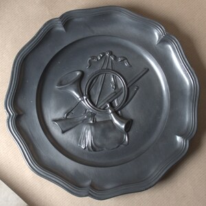 Antique decorative wall plate made of pewter. Hunting.