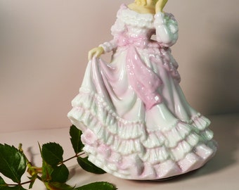 Vintage porcelain music box. Lady in a dress with a bow. Germany.