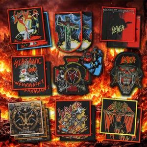 May include: A selection of black embroidered Slayer patches. The designs include the band's logo, album artwork, and various graphics, with red, white, and yellow detailing. The patches are square and rectangular, some with text.