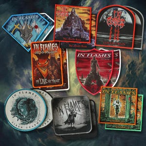 May include: A collection of embroidered fabric patches featuring various In Flames album artwork and logos. The patches include rectangular, diamond, circular, and shield shapes with colourful graphic designs, text, and borders in various sizes and styles.