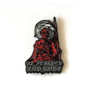 May include: A black and red enamel pin featuring a skeletal figure with a halo, sitting on a throne of black spikes. The figure is wearing a red robe and has a crown of thorns.