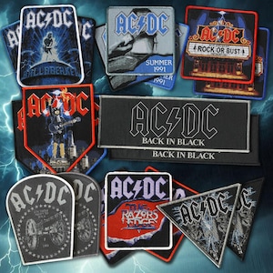 May include: A collection of embroidered AC/DC fabric patches featuring various album artwork and logos, including Ballbreaker, Summer 1991, Rock or Bust, Back in Black, and The Razors Edge. The patches are displayed in assorted shapes and sizes.