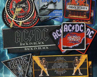 May include: A collection of embroidered AC/DC fabric patches in various shapes and sizes. Designs include the Back in Black logo, The Razors Edge, Rock or Bust, and 1981 For Those About to Rock with cannon graphics and lightning bolt motifs.
