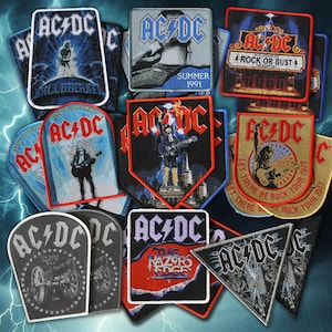 May include: A selection of AC/DC band patches in diverse shapes and designs. The patches display the band's logo, album artwork, and tour graphics. Colours include black, red, blue, and gold. Some patches feature text such as "Rock or Bust" and "Summer 1991".