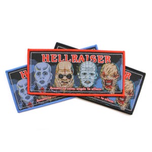 Op de afbeelding: Geborduurde rechthoekige patches met personages uit Hellraiser. De patches hebben een zwarte achtergrond met het woord "HELLRAISER" in rode letters. De patches bevatten ook de tekst "Demons to some, angels to others."