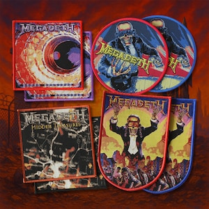 May include: A selection of Megadeth patches with diverse designs. Some patches feature a skull figure, while others display album art and the band's logo. The patches are in various shapes and sizes, with vibrant colours.