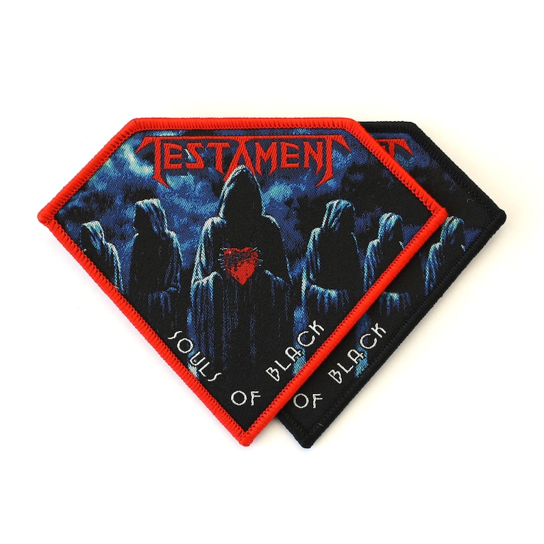 May include: Two diamond-shaped embroidered patches featuring the Testament band logo in red text at the top. The design depicts hooded figures in blue tones holding a red heart. The text Souls of Black is printed in white at the bottom.