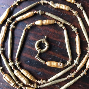 Gold tone pearl w Tuareg brass tubular beads.