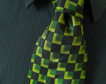 May include: A dark green and lime green patterned tie with a geometric design. The tie is made of a silky fabric.