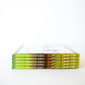 May include: A stack of five green, yellow, and brown paperback books with the title "The Tooth Fairies" and the author "Richman Bell" on the spine.