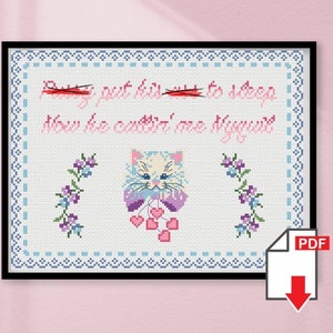 May include: Cross-stitch pattern featuring a white cat with pink and purple accents holding pink hearts. The text reads "Put him to sleep now he can't see me anymore".